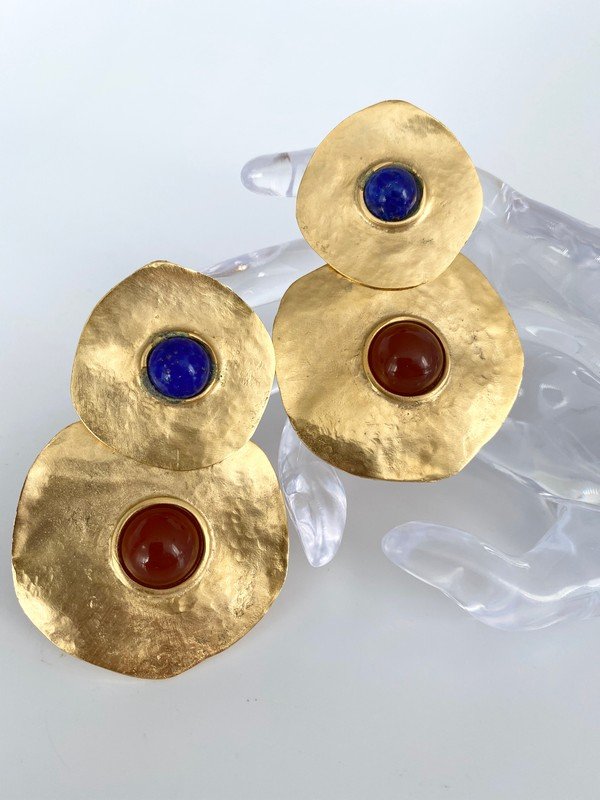VINTAGE HAMMERED DISC JEWELED OVERSIZED RUNWAY EARRINGS: An unsigned pair of ear clips by Les bernard measuring 3 1/4" long with genuine lapis and carnelian cabochons