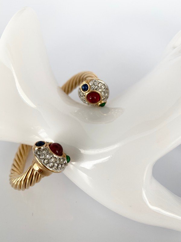 VINTAGE 80'S CLASSIC RUBY EMERALD SAPPHIRE GRIPOIX CUFF: A classic goldtone cable bracelet covered with clear crystals with faux ruby emerald and sapphire gripoix stones. 2 1/2" oval