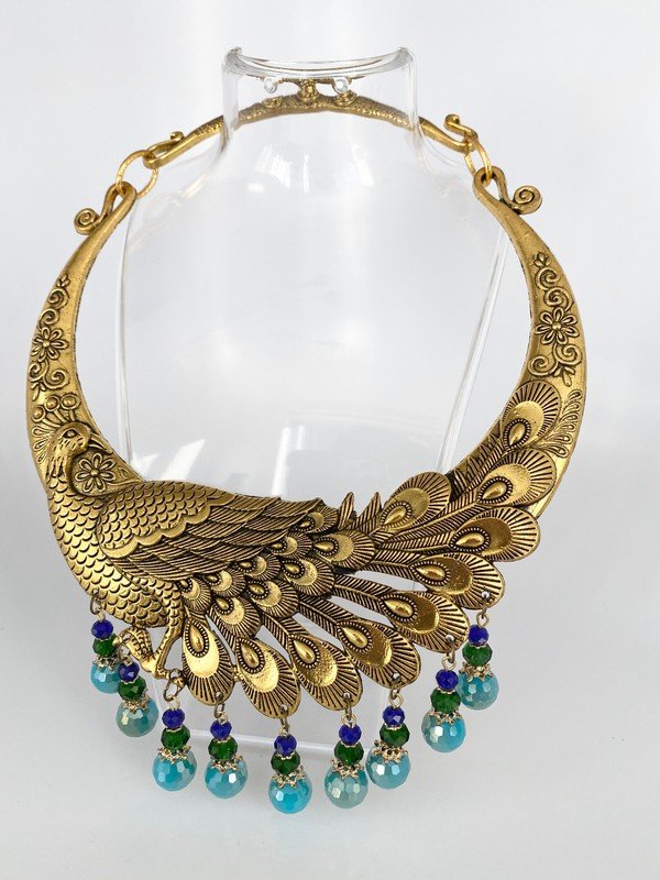 1 OF A KIND VINTAGE JEWELS OF FANTASY PEACOCK NECKLACE: A rare and substantial jewels of fantasy necklace with 9 stations of dangling facet cut crystls. High relief detailing on the peacock, clasp opens on the side of tail and fits up to a 24" neck. This l