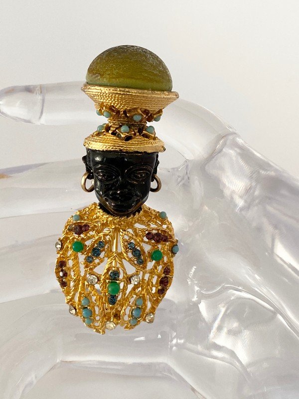 AN EXCEPTIONAL VINTAGE CINER SAMPLE BLACKAMOOR BROOCH: A hard to find jeweled unsigned sample from the 60's from Ciner. A very regal jeweled blackamoor that measures 2 1/2"