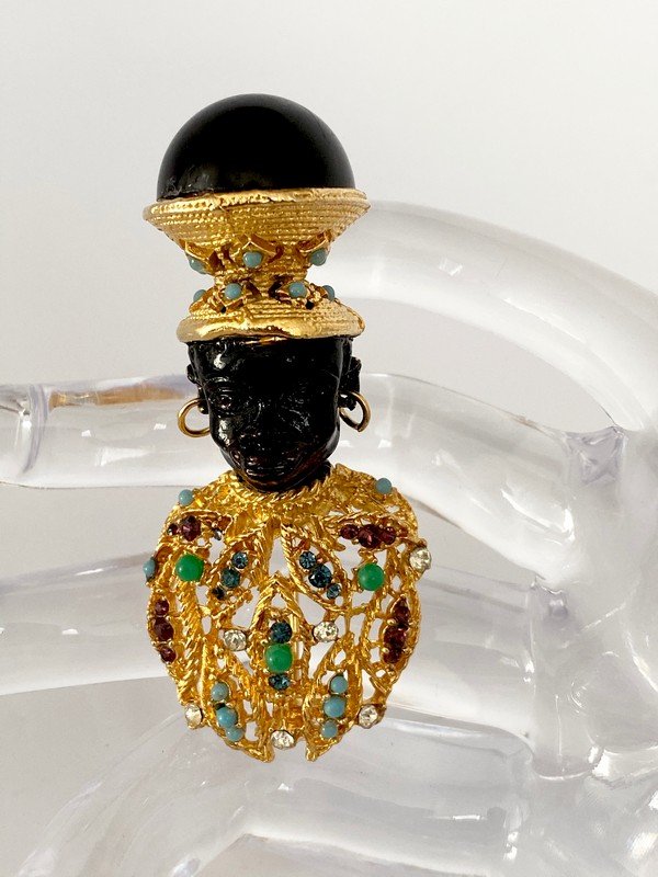 AN EXCEPTIONAL VINTAGE CINER SAMPLE BLACKAMOOR BROOCH: A hard to find jeweled unsigned sample from the 60's from Ciner. A very regal jeweled blackamoor that measures 2 1/2"