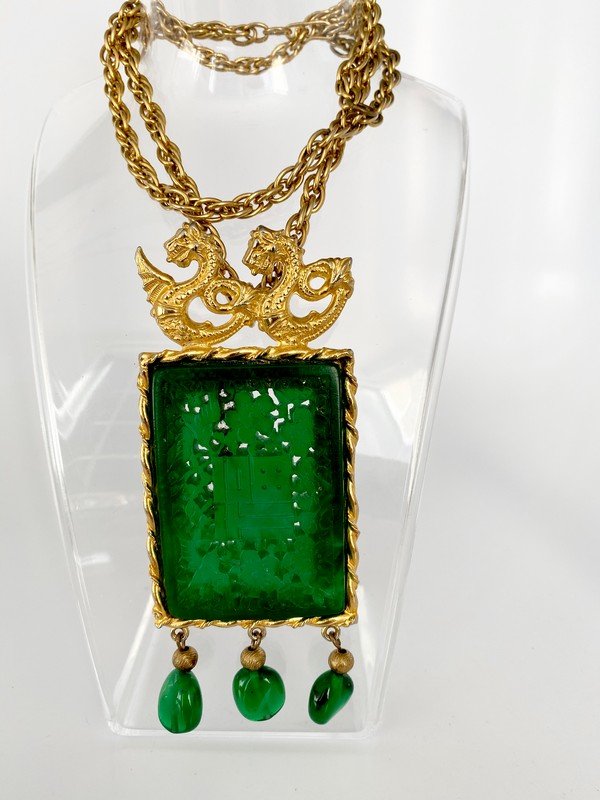 VINTAGE RARE KENNETH LANE JADE GLASS ASIAN NECKLACE: A rare necklace by Kenneth Lane from the 60's with double dragons a large carved intricate faux jade panel framed in goldtone with 3 emerald glass beads. Chain measures 24" and the pendant measures 5"