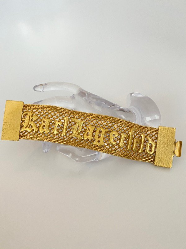 RAREST VINTAGE KARL LAGERFELD 80'S RUNWAY LOGO BRACELET: An important heavy logo bracelet by Karl Lagerfeld. The piece measures 8" and is not quite 2" wide. Never worn from a private collection.