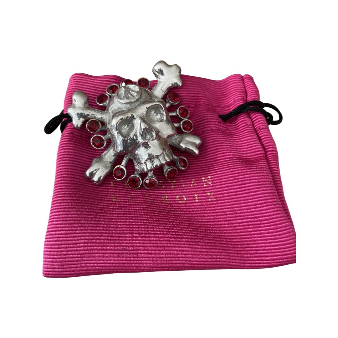 RARE CHRISTIAN LACROIX PARIS RUNWAY SKULL & BONE BROOCH: A very rare signed Christian Lacroix Paris made in france oversized brooch of a skull and cross bones with bezel set ruby rhinestones. Mint condition - measures 2 1/4". Pouch pictured not included