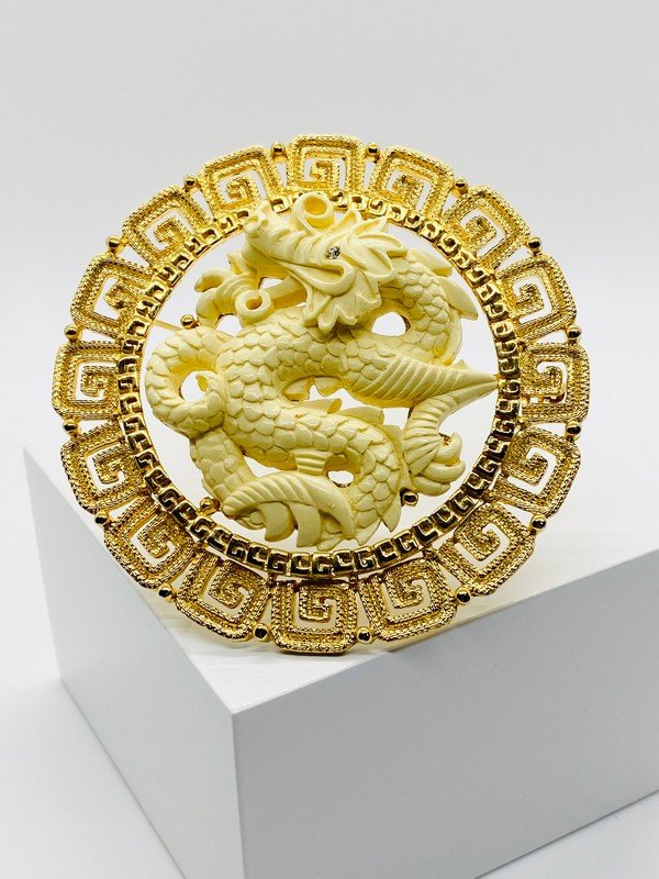 VINTAGE SIGNED HATTIE CARNEGIE OVERSIZED CARVED DRAGON PENDANT: A signed hattie carnegie 3 1/4" carved resin dragon pendant that can also be worn as a brooch.