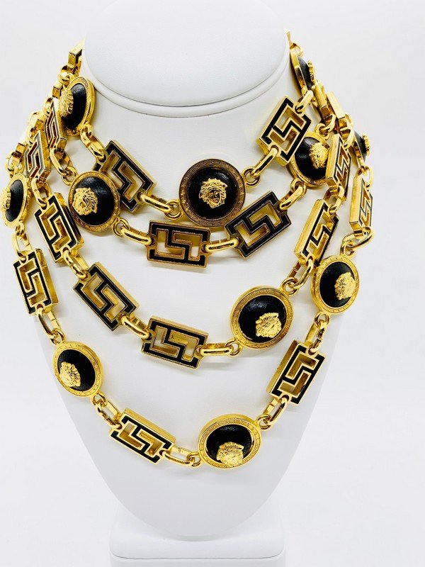 VINTAGE SIGNED PRE-DEATH GIANNI VERSACE RUNWAY LEATHER NECKLACE: A signed mint condition Gianni Versace pre death heavy runway necklace with black enameling and stations with black leather capped with goldplated medusas. Measures 20"