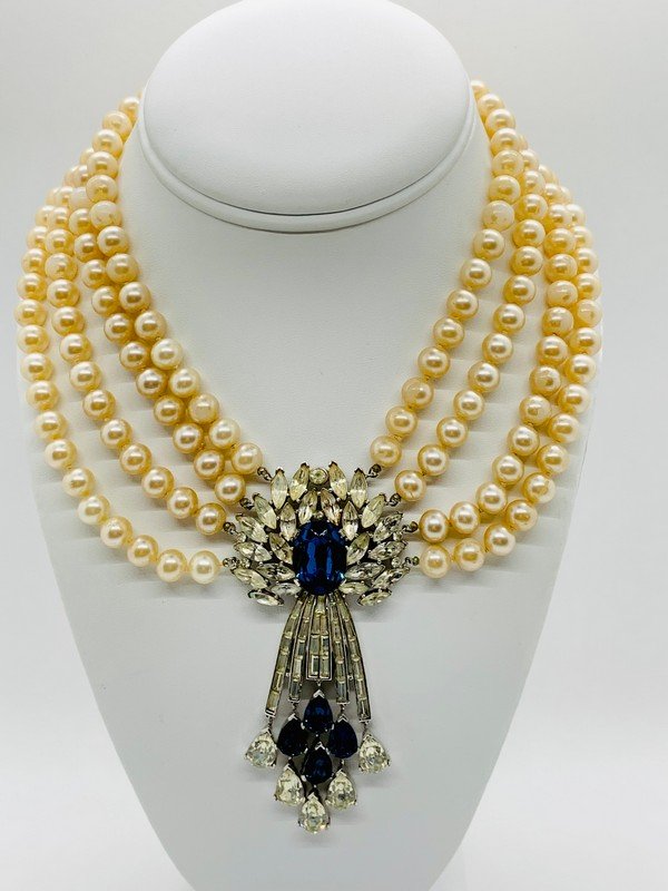 A RARE SIGNED TRIFARI IMPOSSIBLE TO FIND MONTANA SAPPHIRE PEARL MOGUL NECKLACE: A signed trifari hard to find montana blue and clear rhinestone faux pearl necklace. The piece has wear to the pearls but the stones are all perfect. The piece measures 17" with a 4" drop. attached is