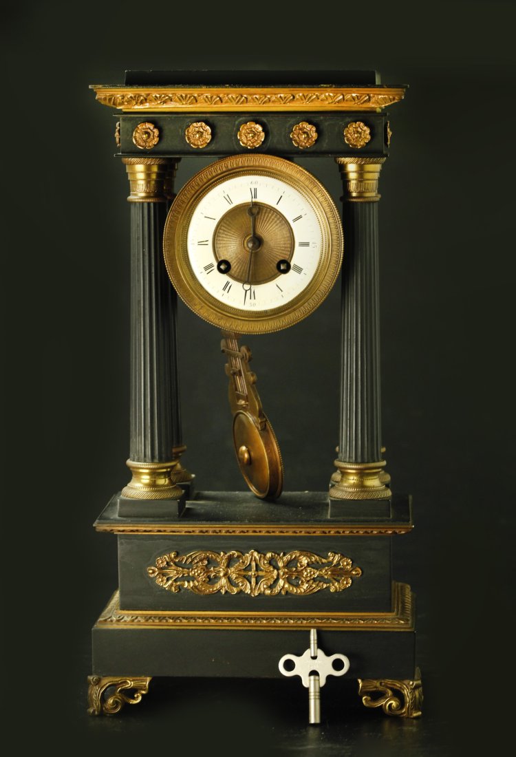 19th century solid bronze with dark patina and gilt bronze mantel clock: 19th century solid bronze with dark patina and gilt bronze mantel clock. W: 8.5 inches, H: 16 inches, D: 5 inches
