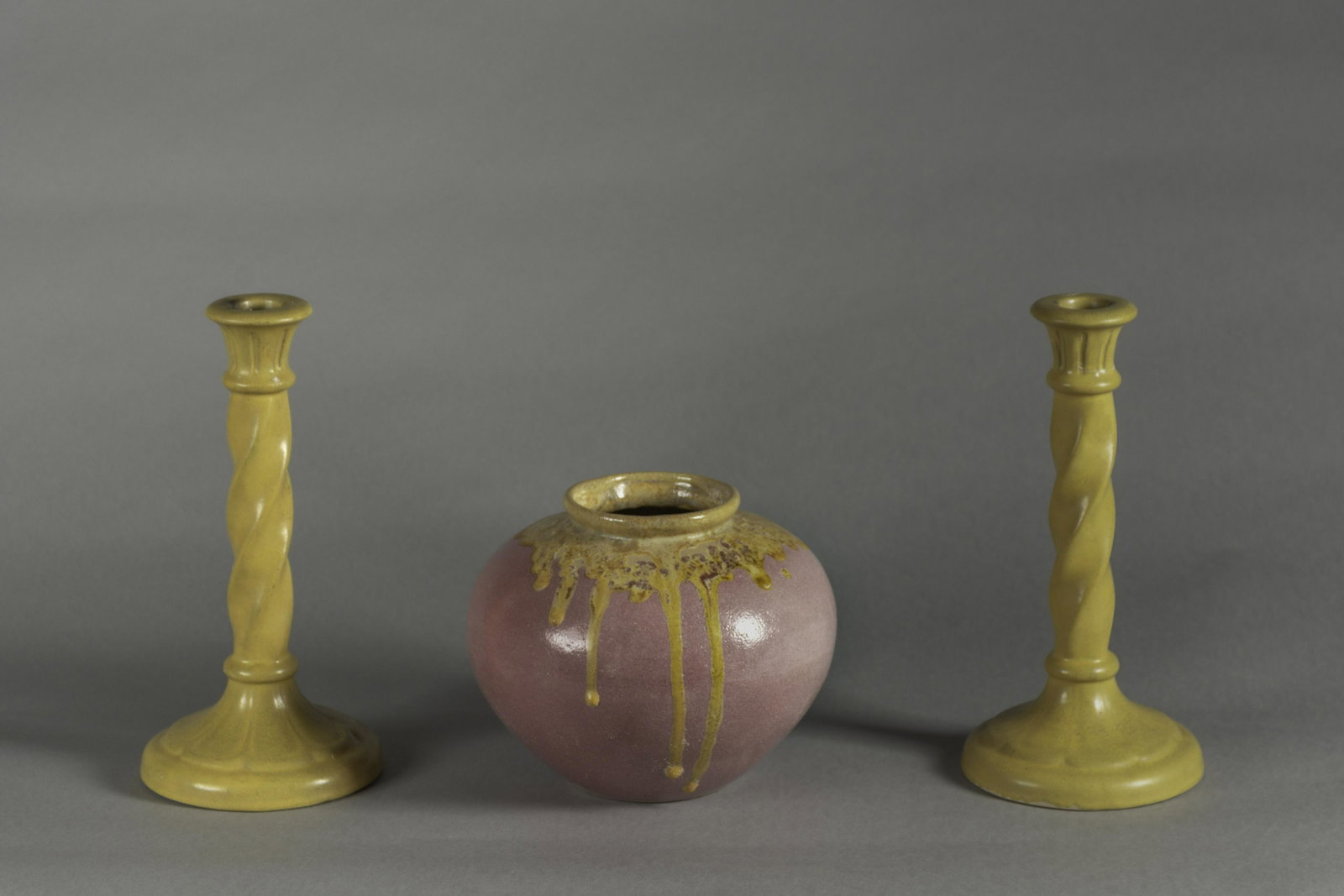 Group of Zanesville Arts & Crafts Pottery (3 pcs.): Zanesville, OH, 1920s. Candlesticks with square box ZANE mark, 10.25 x 8.125"; Ohio art pottery vase with drip glaze with indistinguishable pressed mark, 6.5 x 8"