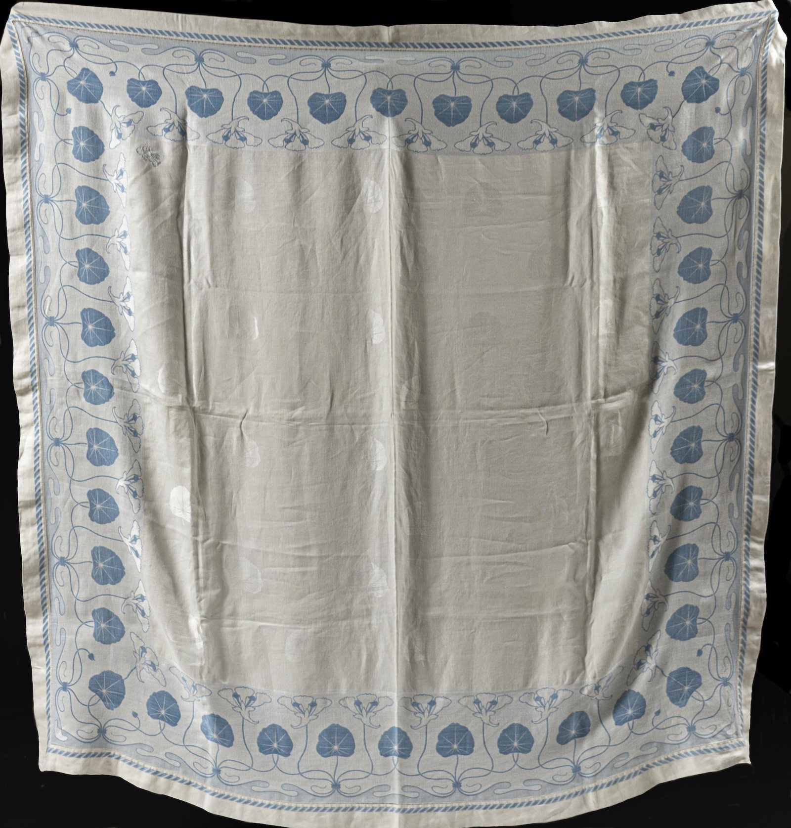 Art Nouveau Woven Tablecloth: Germany, ca. 1900. Of woven silk and cotton, blue and white lilies, monogrammed RB in one corner. 64 x 64 "