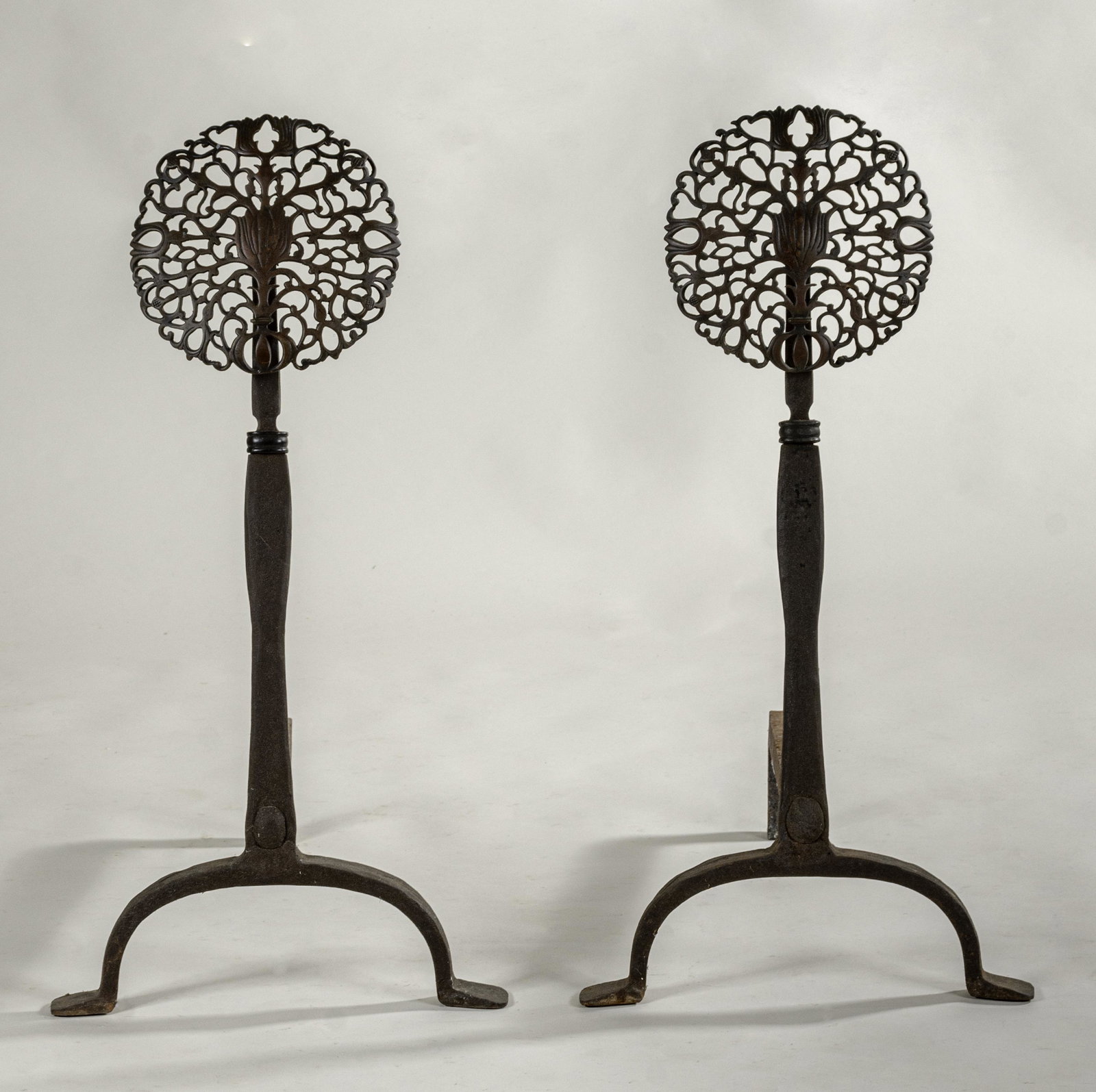 Arts & Crafts Wrought Iron & Brass Andirons (pair): Made by Hoboken Wrought Iron Co., ca. 1920s. In the English taste with cast bronze pierced floral rosettes, 27.5 x 14 x 22" each