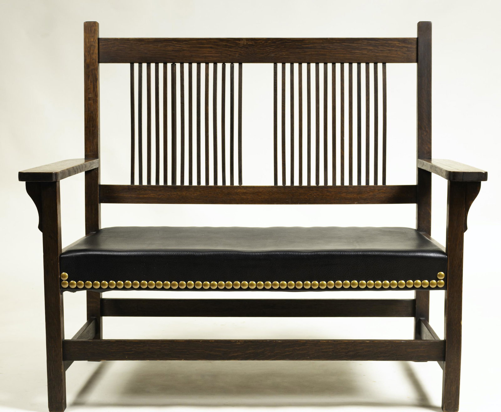 Arts & Crafts Spindle Back Settee: After design by Gustav Stickley, ca. 1910. Oak, leather seat. 41.5 x 48 x 25"