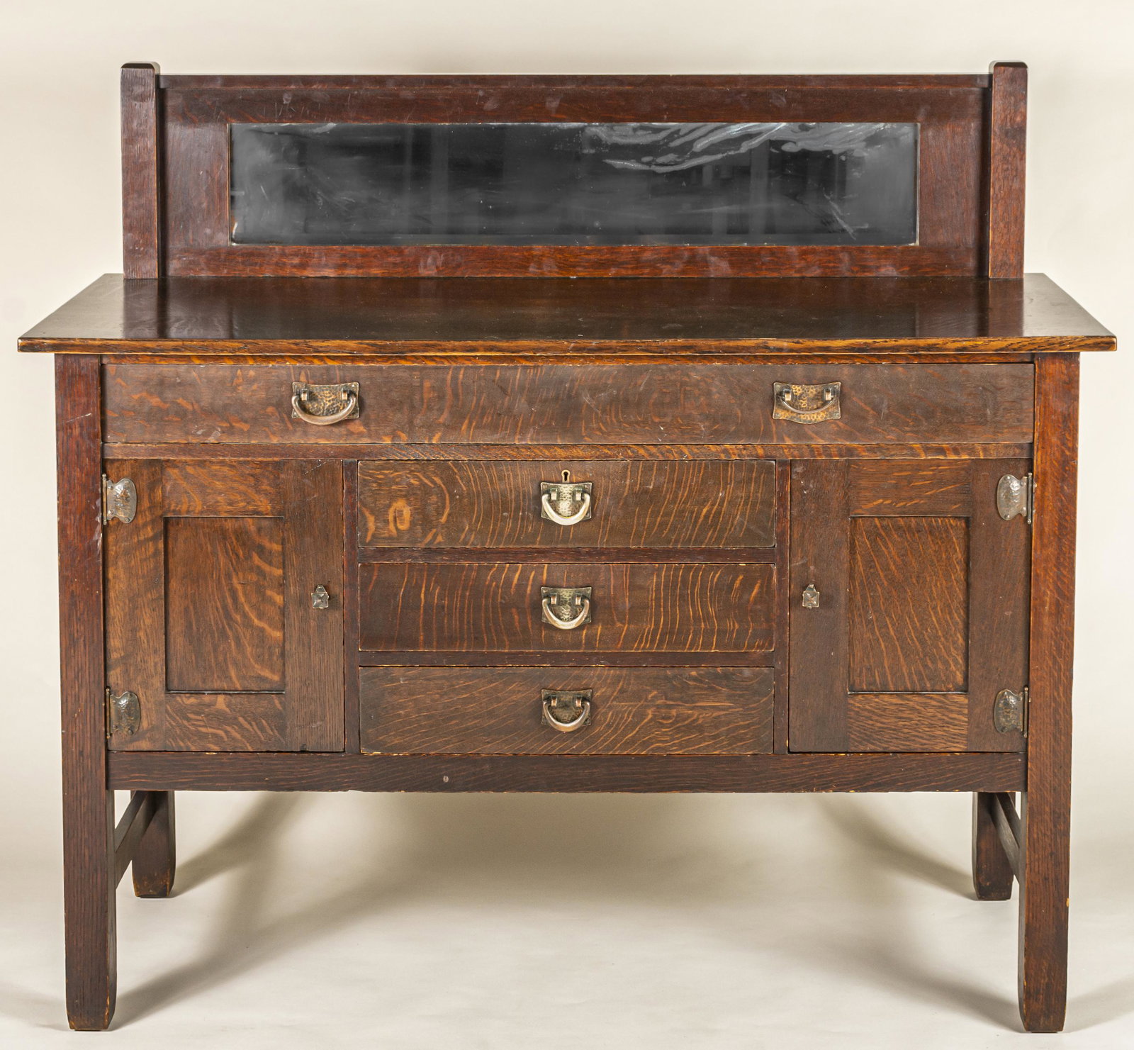 Stickley Brothers Arts & Crafts Sideboard: Grand Rapids, MI, ca. 1910. Quartersawn white oak with hammered copper finish hardware, on reverse stencilled No. 8212, brass Strawbridge and Clothier retail tag inside drawer. 48.5 x 53.75 x 21" (hei