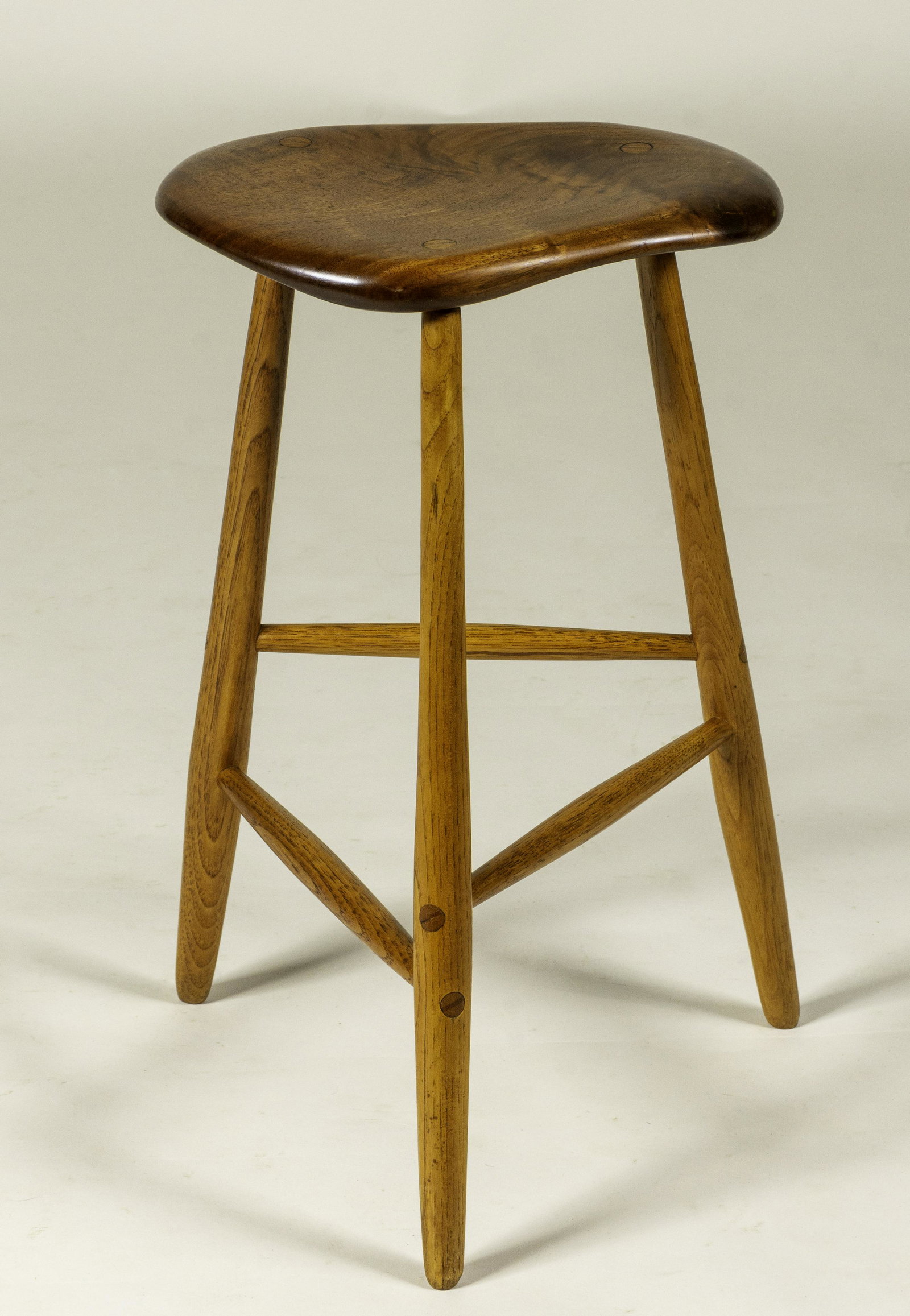Wharton Esherick Stool (after): Stool after a design by Wharton Esherick*, hickory and walnut with shaped saddle seat, unsigned, 20th century, 19.75 x 12 x 9". *Possibly made by Esherick's assistants after his design.