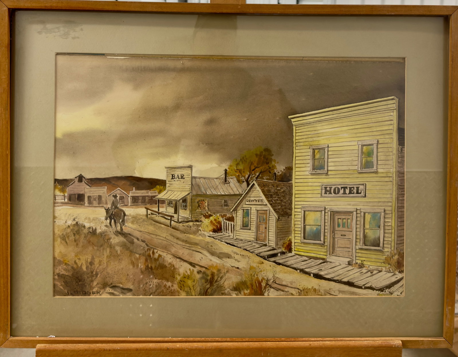 John Lawrence Stoner Signed watercolor Western Town: John Lawrence Stoner Signed watercolor Western Town, SLL, 13 x 19", 19 x 25" Framed John Lawrence Stoner (1906 - 1976) was active/lived in California. John Stoner is known for Painter, printmaker.Born