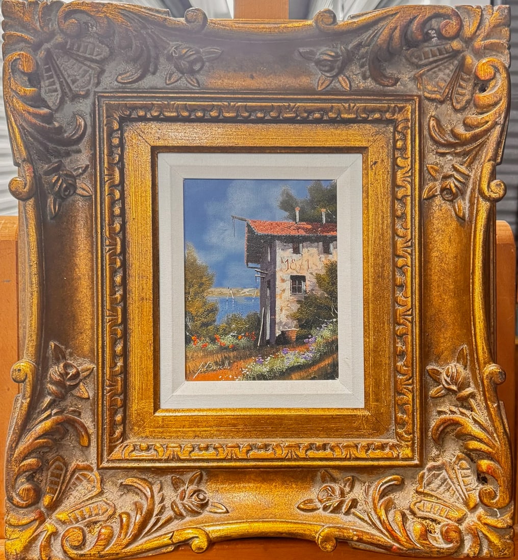 Vintage Italian Impressionist Guido Borelli Signed Oil Painting landscape: This charming original oil painting, signed J. Barelli i, depicts a rustic European villa overlooking a serene landscape with distant water, lush trees, and a bright blue sky. The artist’s delicate 