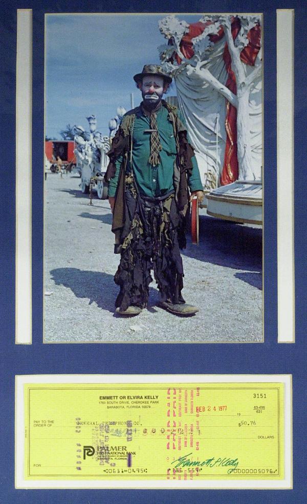 Emmett Kelly - Check Matted: Emmett Kelly (1898-1979) Circus clown. Kelly was famous as "Weary Willie," a sad-faced hobo with the Ringling Brothers and Barnum & Bailey Circus. 8" x 3" check signed, Palmer First national Bank, Feb