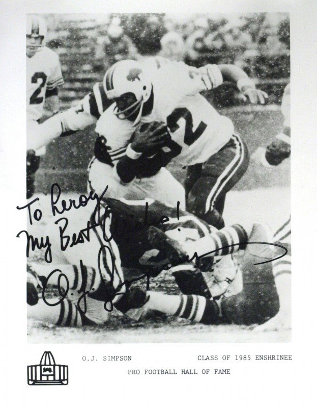 Murderer, Felon O J SIMPSON - Photo Signed: O. J. Simpson (1947- ) Running back, murderer, felon. Simpson was the first NFL player to rush for more than 2,000 yards in a season. He also holds the record for the single season yards-per-game aver