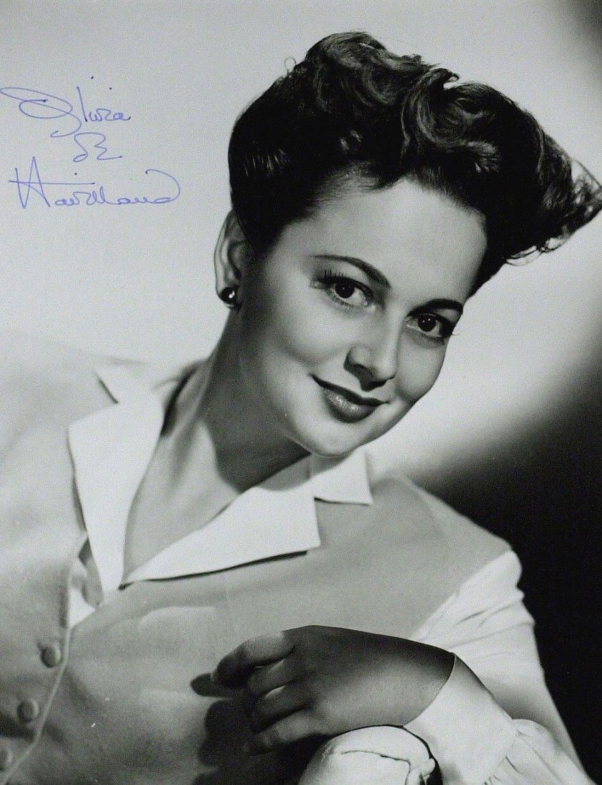 GWTW Actress OLIVIA DeHAVILLAND - Photo Signed: Olivia DeHavilland (1916- ) Actress. De Havilland portrayed Melanie in Gone With the Wind and won an Academy Award for To Each His Own and The Heiress. 10" x 8" black and white photograph signed. Matt