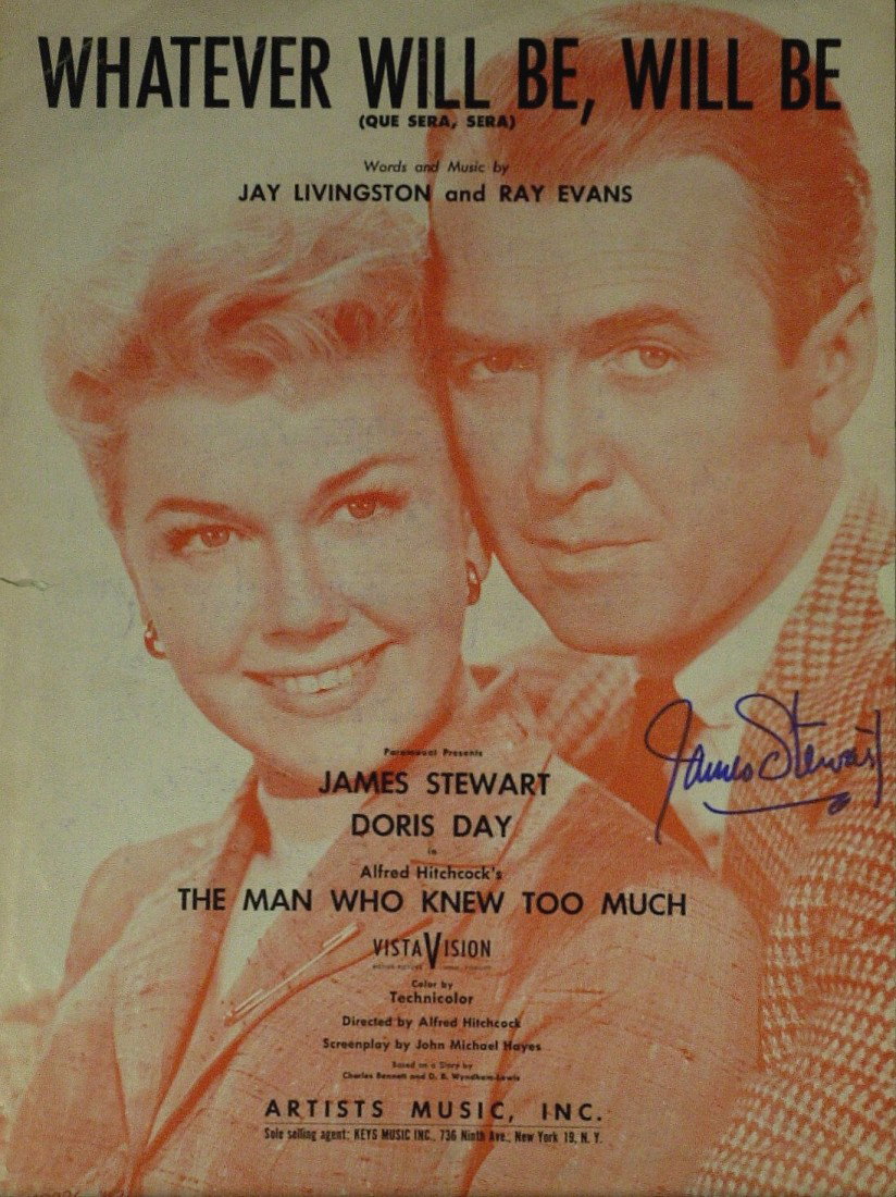 JAMES STEWART - Sheet Music Signed: James Stewart. 9" x 12" piece of sheet music for the song, Whatever Will Be, Will Be, with Stewart and Doris Day pictured on the cover, signed on his image. The song was from the 1956 Hitchcock thrill