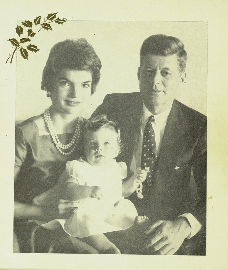 JFK and JACKIE - Unsigned 1958 Xmas Card: (John F. Kennedy). 1958 Christmas Card. 5" x 6" Christmas card with a printed photograph of then Senator and Mrs. Kennedy with daughter, Caroline containing a printed signature "Warmest regards Jack."