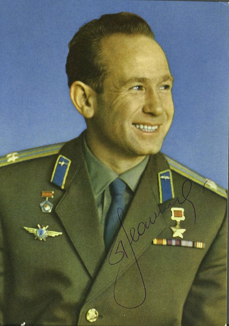 Cosmonaut ALEXSEI LEONOV - Photograph Signed: Alexsei Leonov (1934- ) Cosmonaut. Leonov was the first human to "walk" in space and later he commanded the Soviet half of the 1975 Apollo-Soyuz mission. 4 ¼" x 8" printed color photograph signed. In