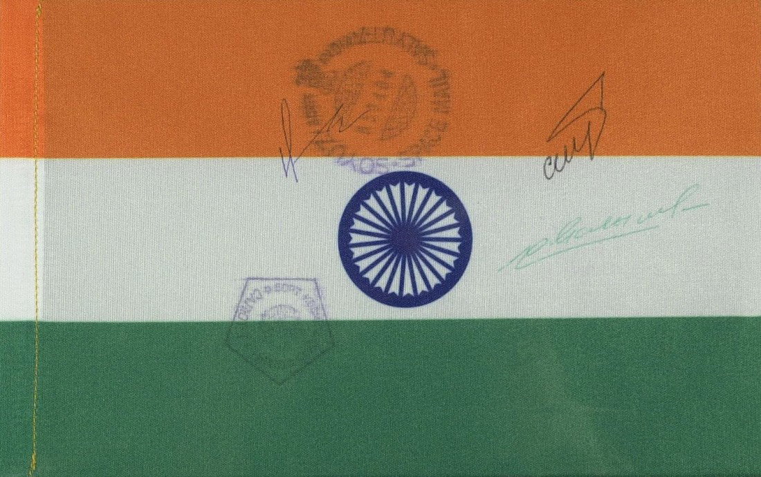 SPACE FLOWN INDIAN FLAG - Signed by Crew: Space Flown Flags: Soyuz T-11. 7 ½" x 4 ½" flown nylon Indian flag signed by the full crew of Soyuz T-11: Soviet cosmonauts Yury Malyshev, Gennadi Strekalo and Indian cosmonaut Rakesh Sharma. The cr