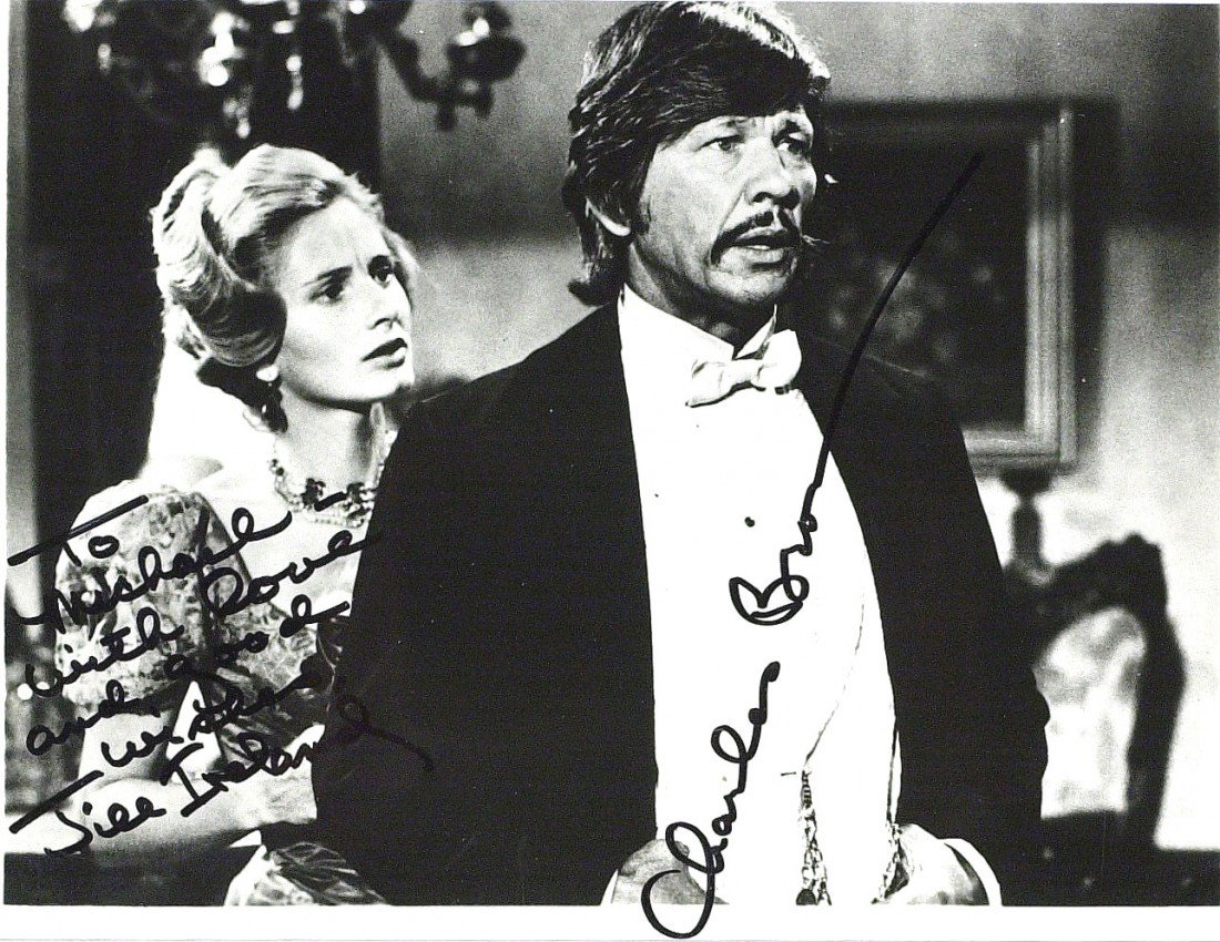 CHARLES BRONSON & JILL IRELAND - Photo Signed: Charles Bronson (1921-2003) and Jill Ireland (1936-1990) Actors. Bronson was best known for his "tough guy" image, who starred in such classic films as Once Upon a Time in the West, The Magnificent Se