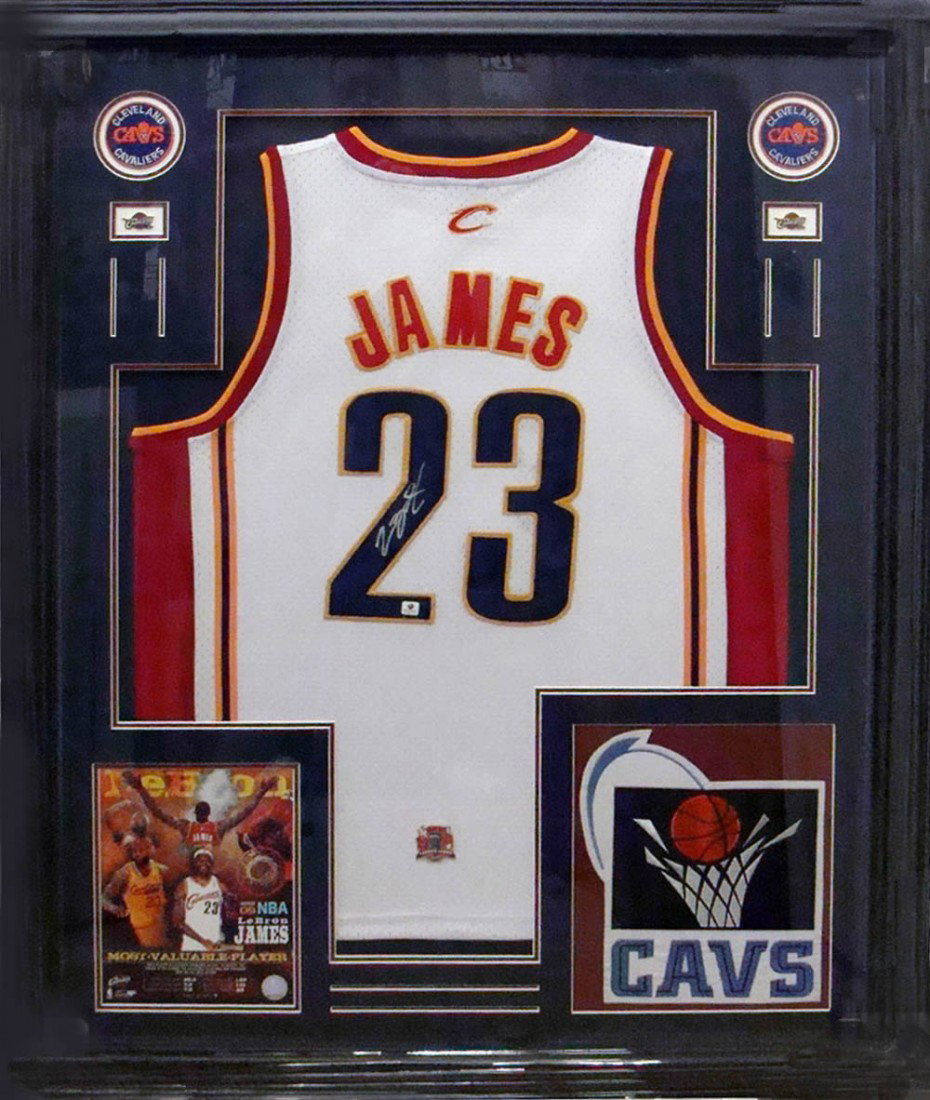 LaBRON JAMES - Cavs Jersey Signed and Framed: LaBron James. A number twenty-three replica white home Cavaliers jersey signed in silver ink. The jersey is double matted with the Cavs logo and an 8" x 10" color action photograph and archivally fram