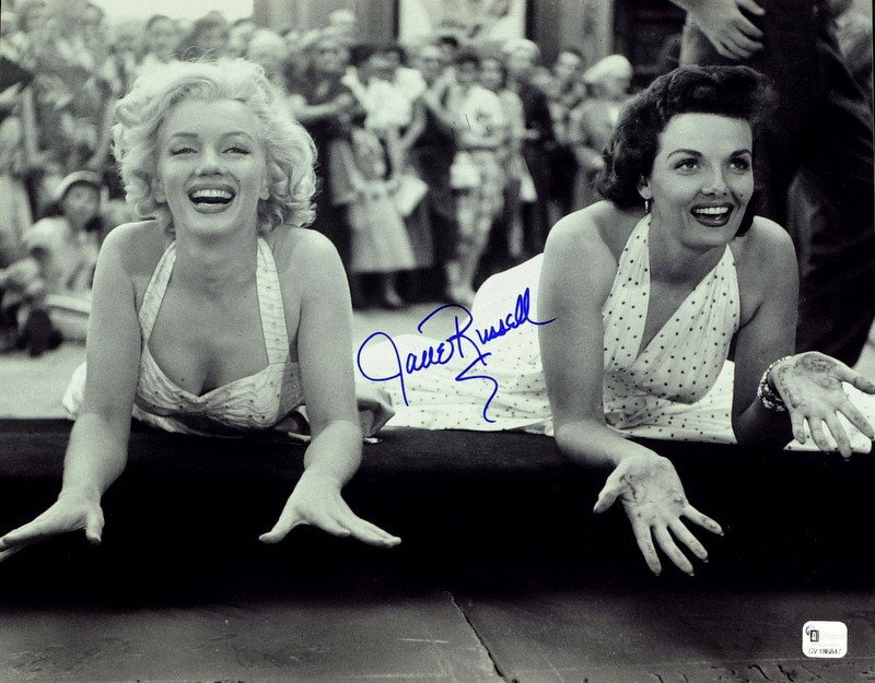 Actress JANE RUSSELL - Photo With Marily Monroe: Jane Russell (1921-2011) Actress. Russell made her motion picture debut in The Outlaw 1n 1941, a story about Billy the Kid that went to great lengths to showcase her voluptuous figure. The release of 