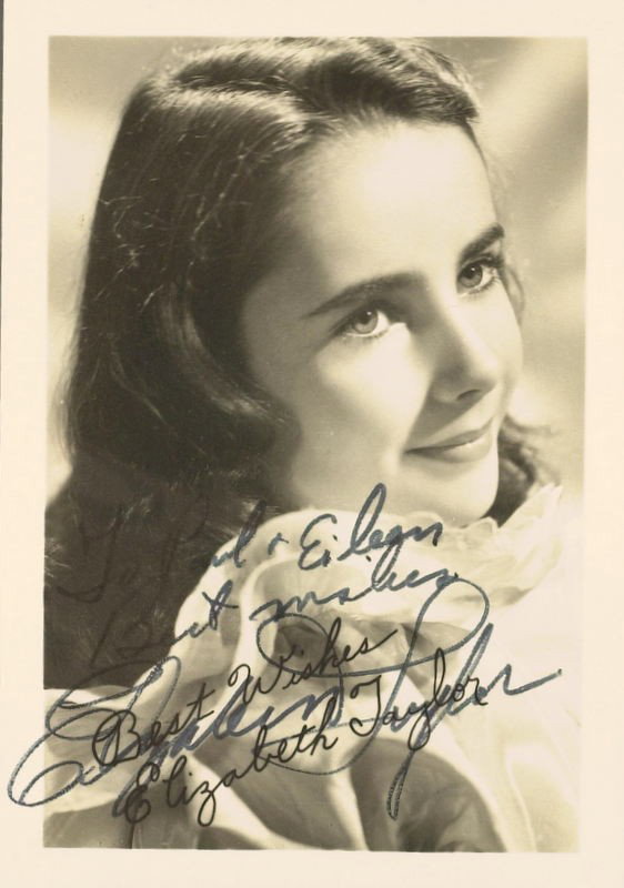 ELIZABETH TAYLOR - Vintage Photo Signed: Elizabeth Taylor. 3 ½” x 5” black and white photograph signed, “Paul & Eileen Best Wishes Elizabeth Taylor.” Signed over a printed signature.