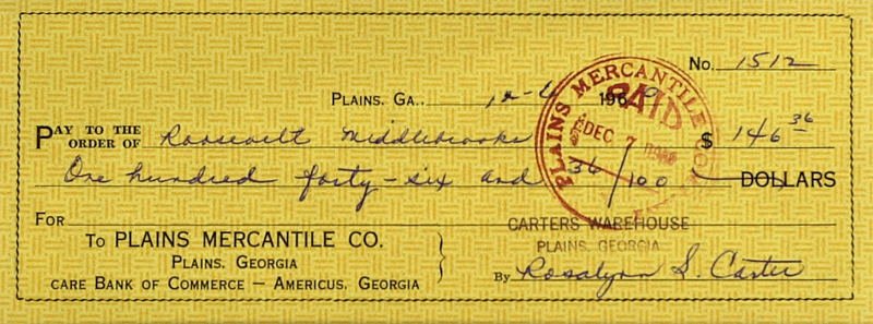 First Lady ROSALYNN CARTER - Check Signed: Rosalyn Carter. 8 ½” x 3 ¼” check written and signed, Plains Mercantile Co., Carters Warehouse account, December 6, 1960, payable to Roosevelt Middlebrooks. There is a circular red cancellation 