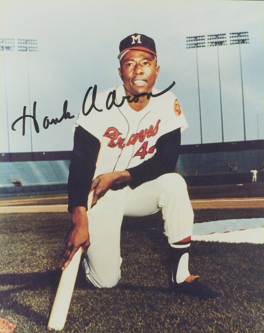 Homerun King HANK AARON - Color Photo Signed: Hank Aaron (1934- ) Aaron became the all-time home-run champion via one of the most consistent offensive careers in baseball history, with 3,771 hits. In addition to his 755 home runs, he also set Maj
