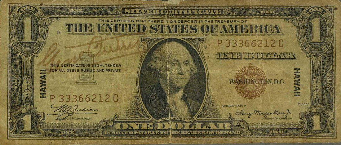 GENE AUTRY - Hawaii Silver Certificate Signed: Gene Autry. 6 ¼” x 2 ½” dollar bill (Silver Certificate 1935 Hawaii issue) signed. Age browned and worn. The reason the bills were printed that way (brown seal and serials, and "HAWAII" overprin