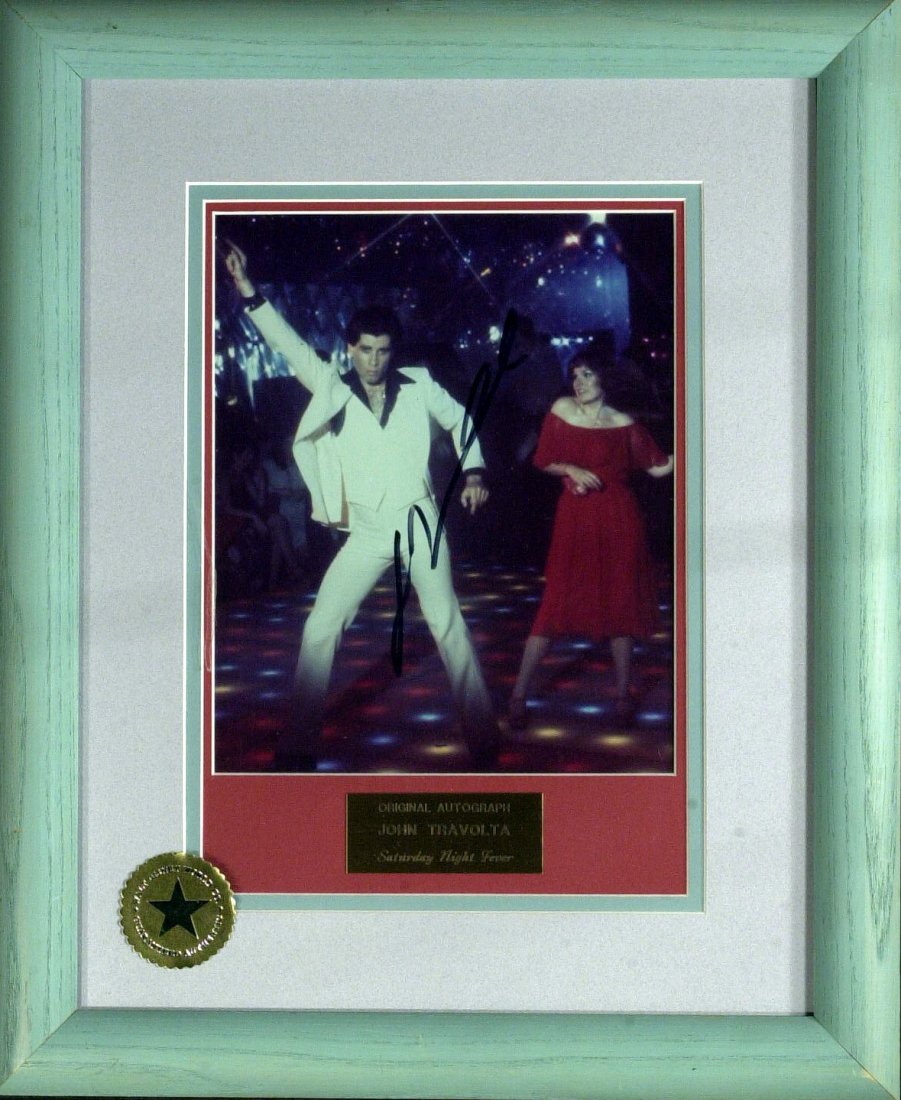 Actor JOHN TRAVOLTA - Framed Signed Photo: John Travolta (1954- ) Actor. Travolta first became known in the 1970s, after appearing on the television series Welcome Back, Kotter and starring in the box office successes Saturday Night Fever and