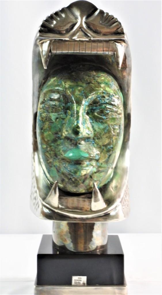 Silver sculpture of an animal cat head with a human (1 of 17)