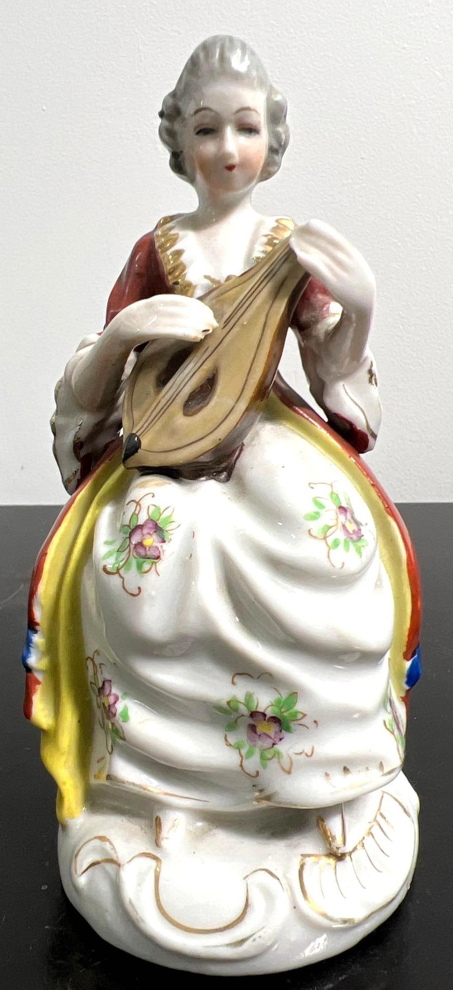 Occupied Japan Porcelain figurine, women playing instrument. (1 of 6)