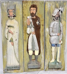 Three wood carvings representing two man and a woman