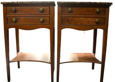 A pair of side tables with marble tops