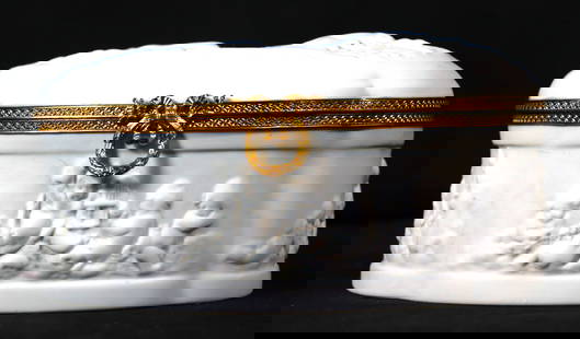 Limoges bisque porcelain box with ormolu mounts.from France: Limoges bisque porcelain box with ormolu mounts. Figural motif of seated women with cherubs to lid and depictions of cherubs playing to sides. Marked to underside. DIMENSIONS: Height: 3.75 inch