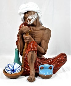 Large Algora porcelain seated old man figurine.