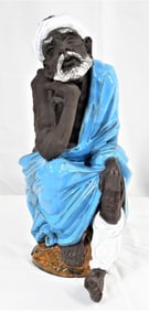 Large Algora porcelain seated old man figurine.