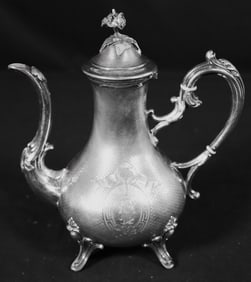 Sterling silver coffee pot, engraved with a monogram, and scrolling handle