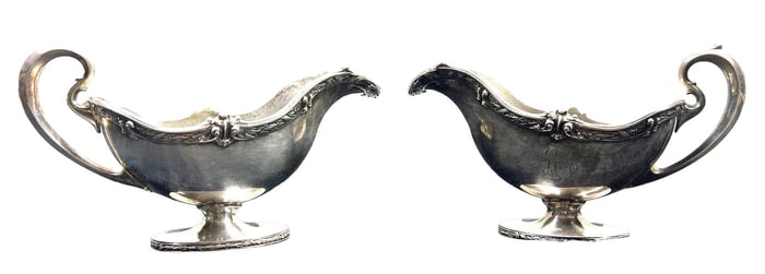 A pair of  sterling silver sauce boats with acanthus handles and   engraved design.
