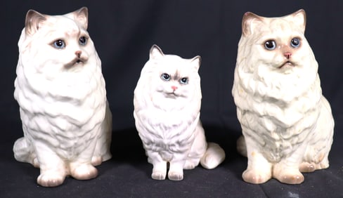 Three White Porcelain Persian Cats with blue eyes