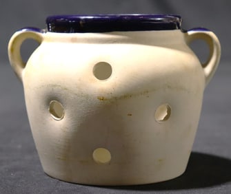 Ceramic garlic keeper, also referred to as a garlic jar or crock