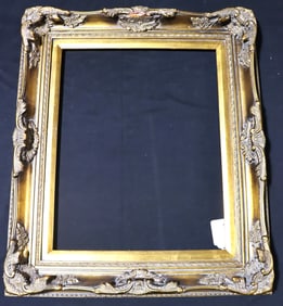 Ornate, antique-style gold picture frame with a Baroque or Rococo design.