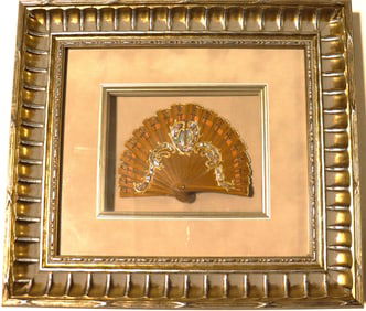 Vintage hand fan within a decorative box frame