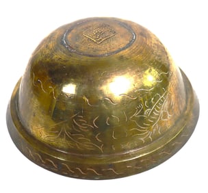 Chinese brass bowl with etched dragon and wave motifs.