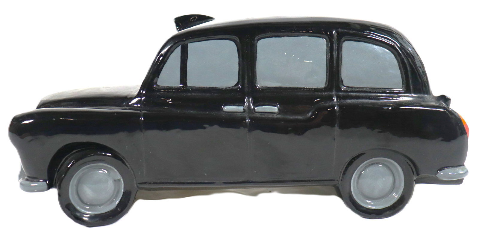 Vintage Porcelain Black London Taxi-cab made in England: Vintage Porcelain Black London Taxicab made in England It is a model of an Austin FX4 London taxi, a common symbol of London. The model is black with grey wheels and appears to be made of ce